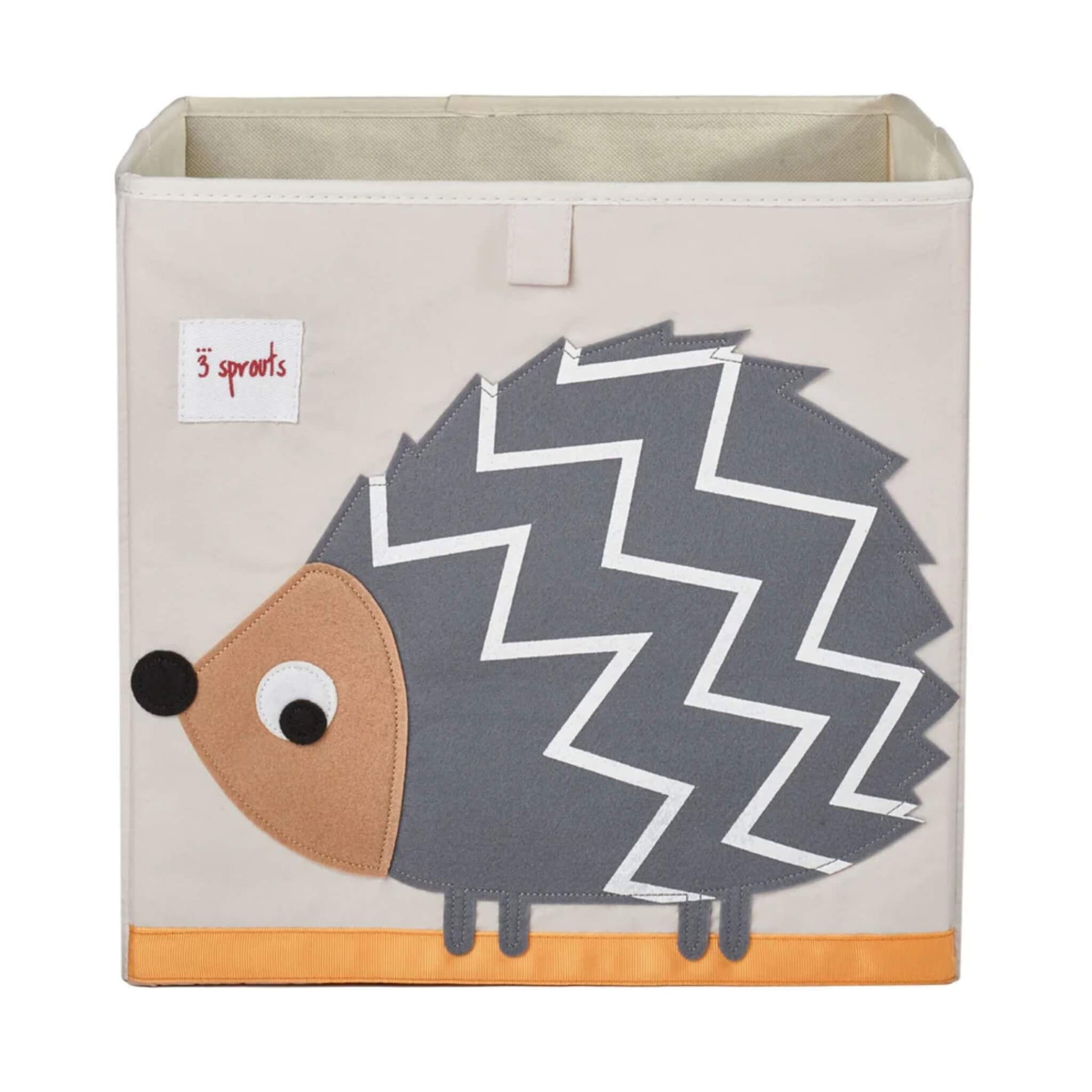Cream-coloured fabric storage box with a large appliqué of a grey and white zigzag-patterned hedgehog and orange trim along the base.