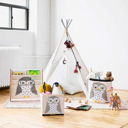 The owl storage box shown in a child’s playroom, styled alongside a matching owl book rack and a round play tent.