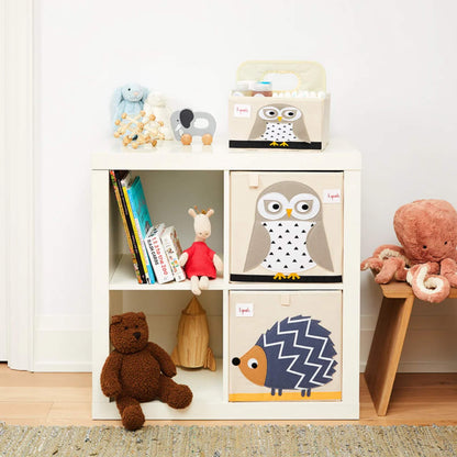 Owl storage box placed in a cube shelf next to soft toys and books, paired with a hedgehog box and baby accessories.