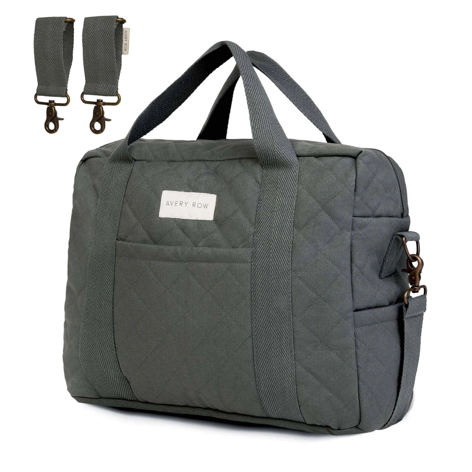 Avery Row Baby Changing Bag in Flint grey canvas with quilted finish, carry handles, detachable shoulder strap and pram clips shown alongside the bag.