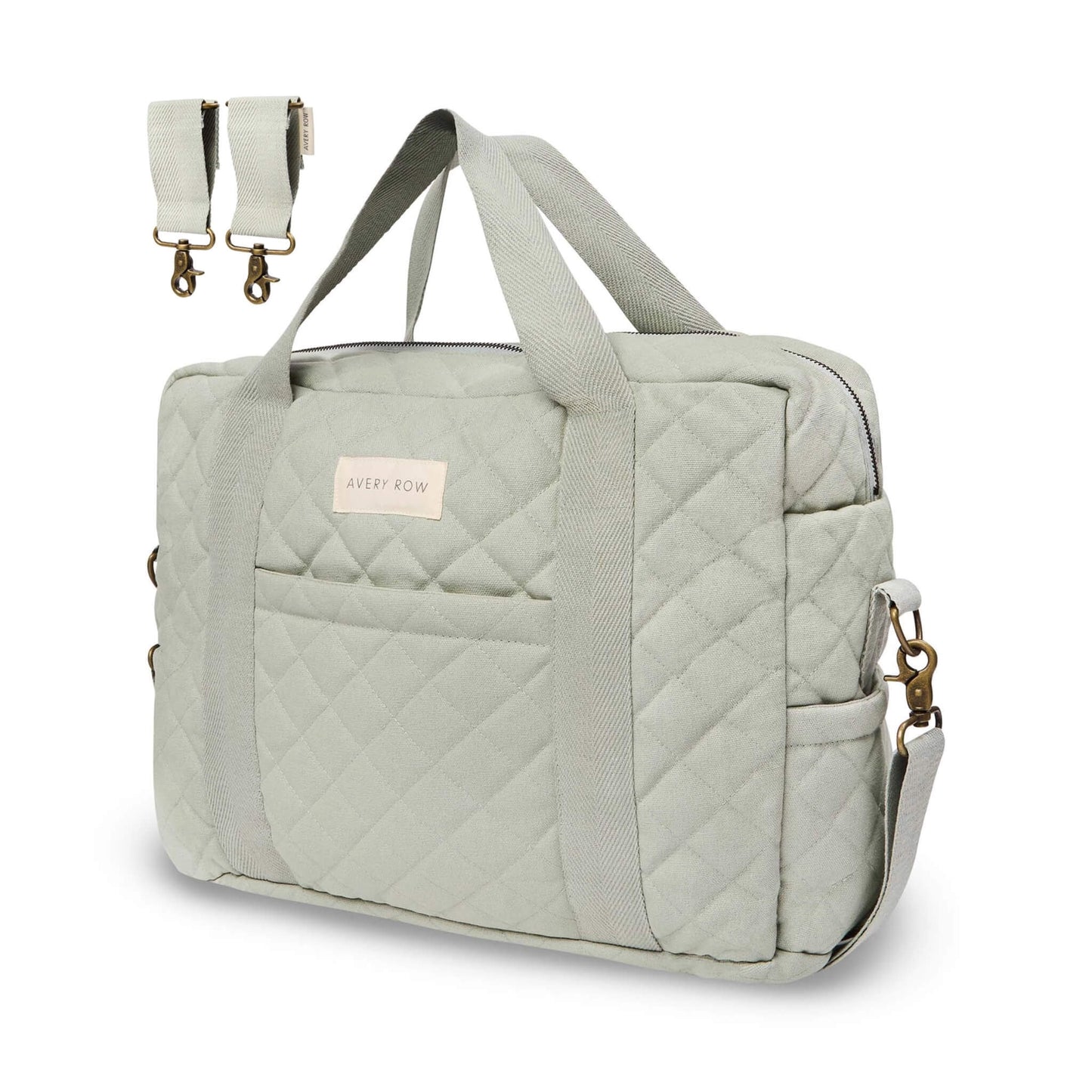 Avery Row baby changing bag in sage green quilted cotton with long shoulder handles, zip top and detachable pram clips shown beside bag.