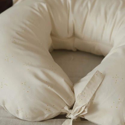 Close-up of a cream nursing pillow showing the Wild Chamomile print and fabric tie fastening.