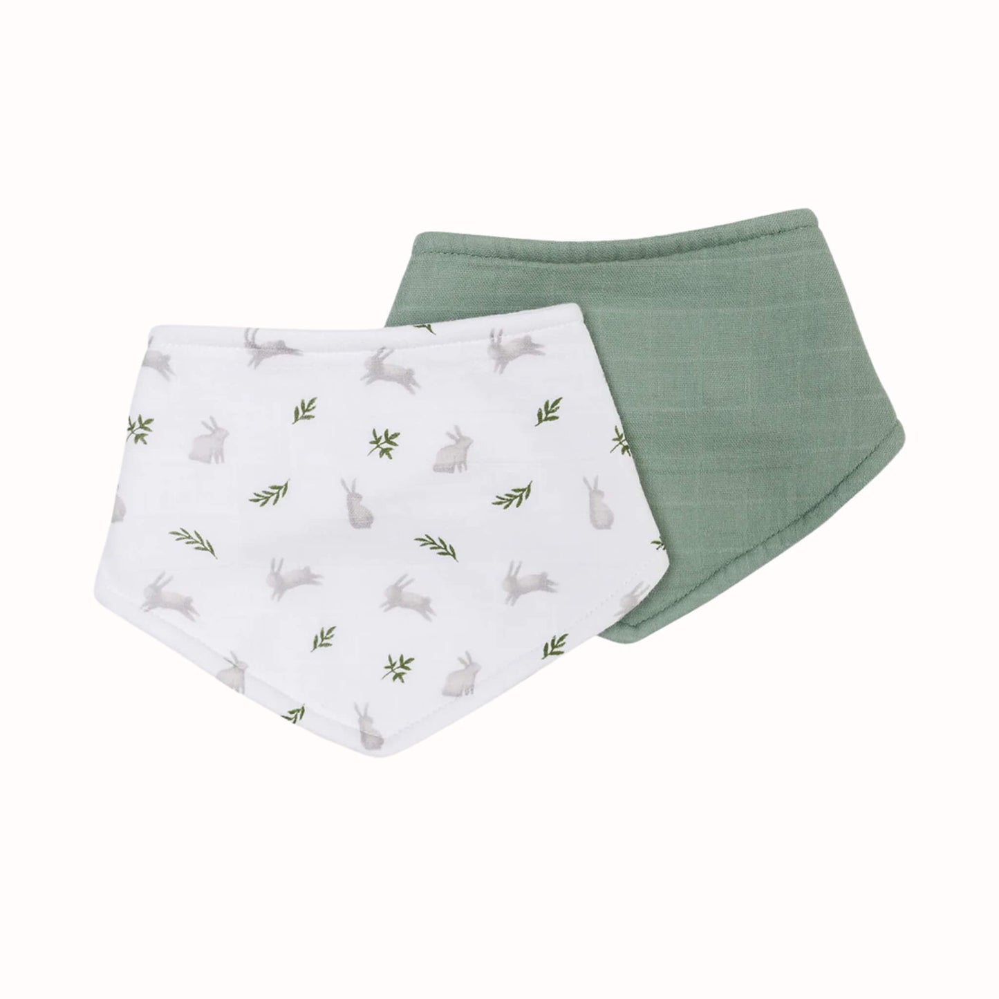 Two muslin bandana bibs displayed overlapping, including one white bib with grey bunny and green leaf print and one plain sage green bib.