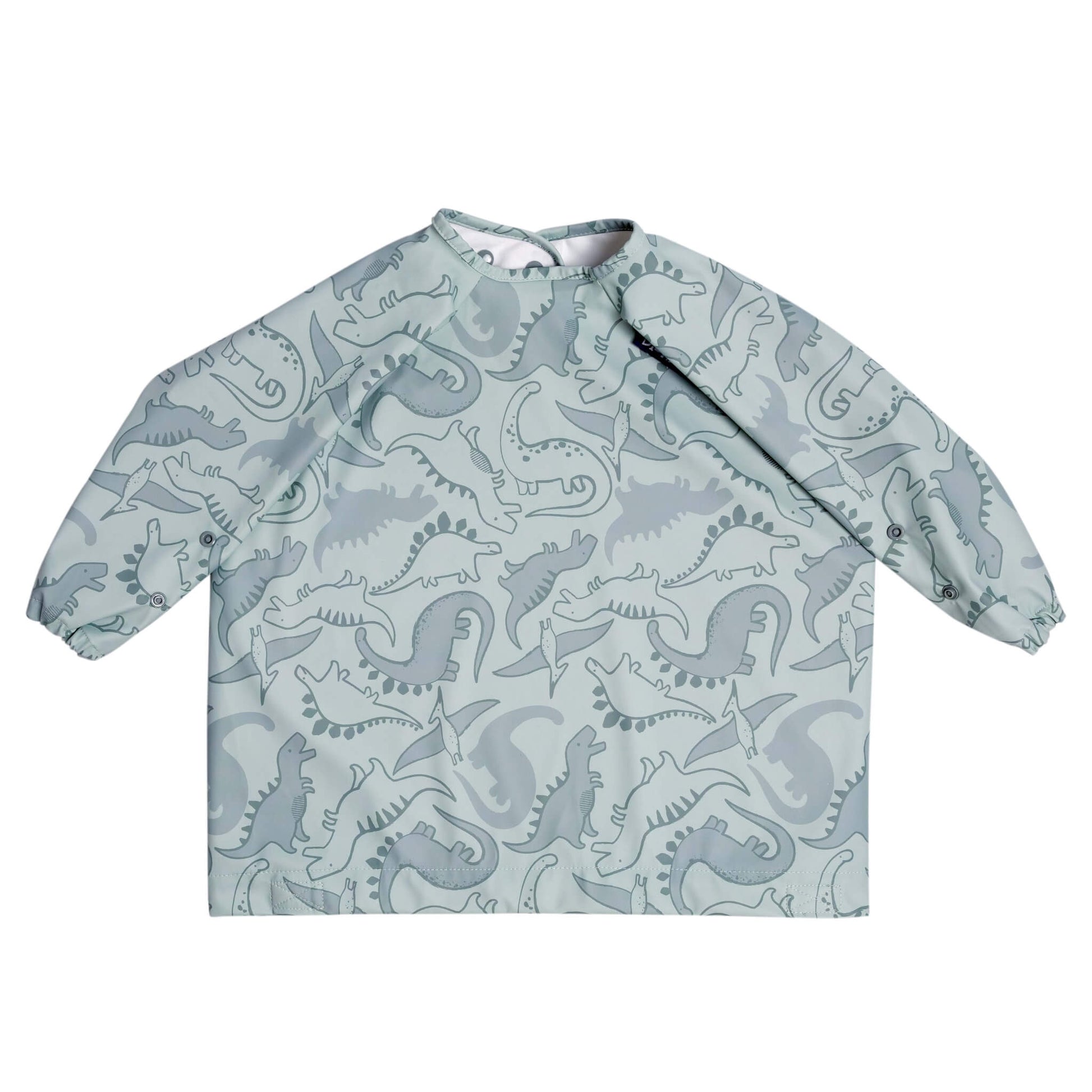 Dino Roar Bibado bib laid flat without the strap, showing full sleeve coverage and dinosaur-themed print on soft sage green fabric.