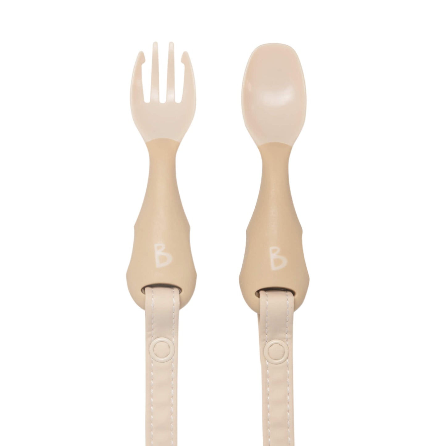 Bibado Handi Cutlery in Fawn with ergonomic spoon and fork laid flat, popper straps attached and ready for weaning.