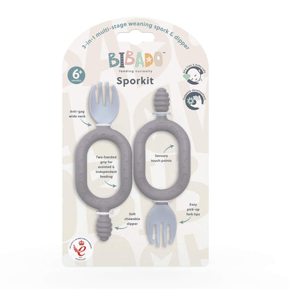 A twin pack of mist blue self-feeding utensils in retail packaging with dual handles, textured dippers and baby sporks.