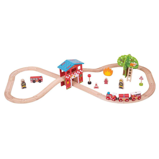 A complete view of the Bigjigs Toys Fire Station Train Set laid out in a figure-of-eight track, featuring red fire-themed trains, a fire station building, ladder, tree, fire truck, fire crew, and accessories.