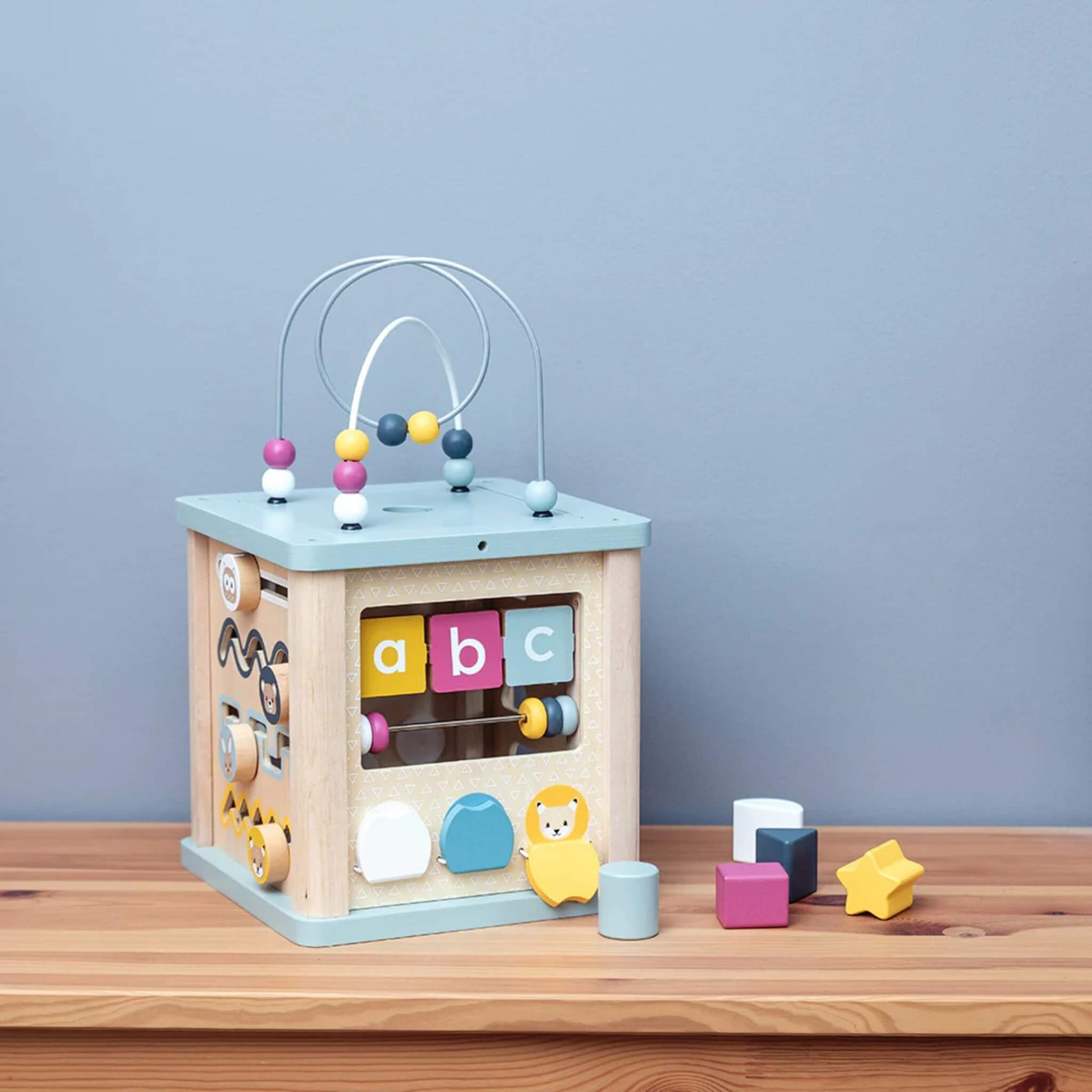 Wooden activity cube with colourful ABC blocks and bead maze, perfect for early letter recognition and tactile play.