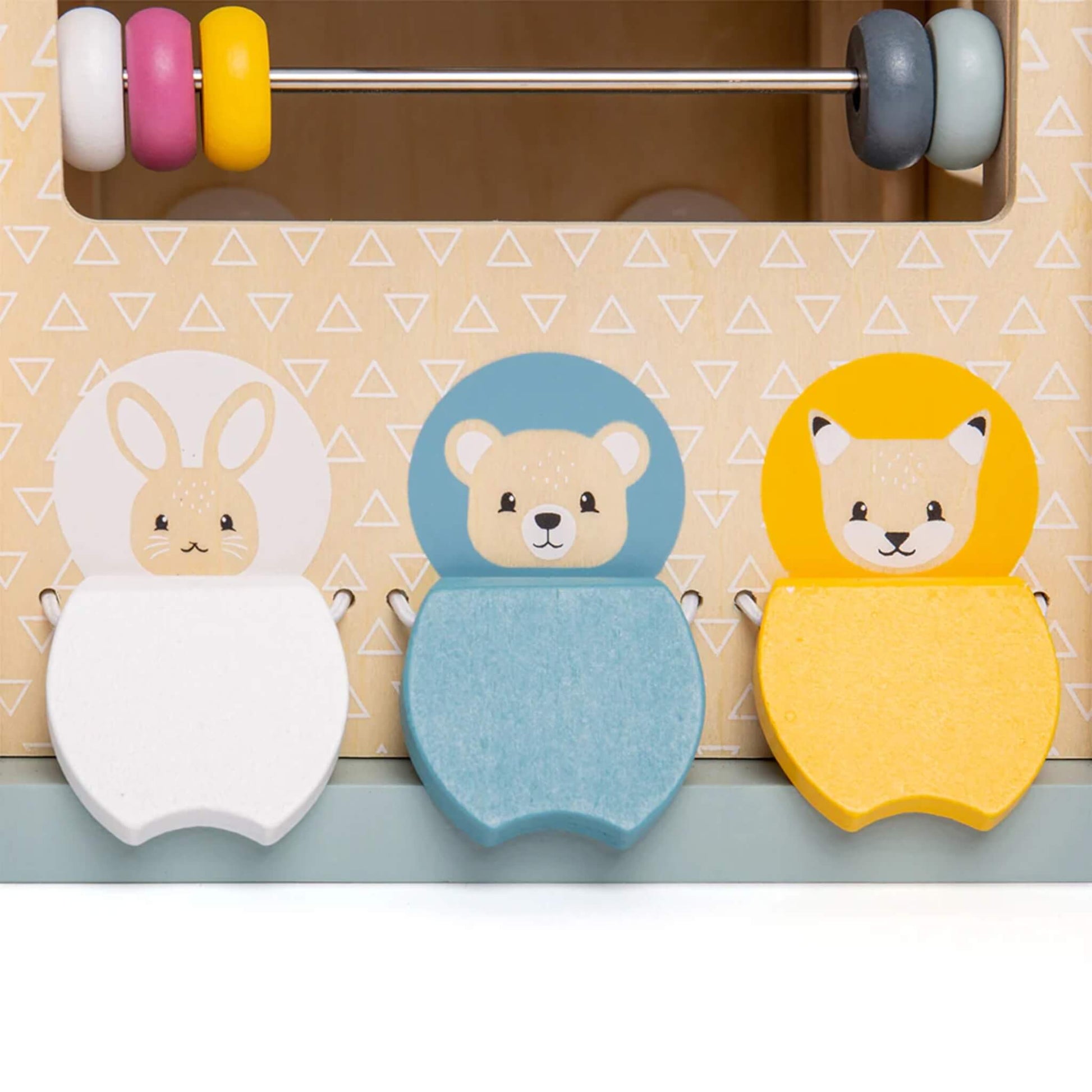 Three wooden animal tiles – rabbit, bear, and fox – on the side of an activity cube, promoting imaginative play and shape matching.