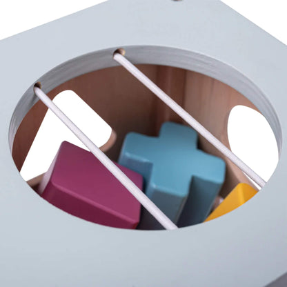 Top-down view into the shape sorter, showing stored shapes through elastic bars.