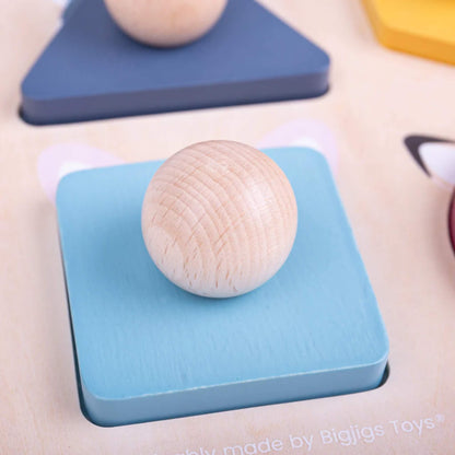 Close-up of the blue square puzzle piece with wooden knob from the Bigjigs Toys Woodland Shape Puzzle.