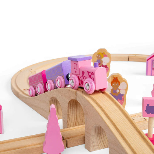 Pink fairy-themed engine with two carriages crossing the wooden raised bridge, with fairy figures in the background.