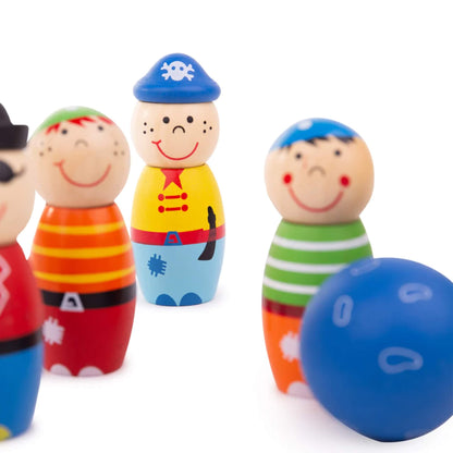 Wooden pirate with an eyepatch stands in front of the full skittles set, with bright colours and smiling faces.