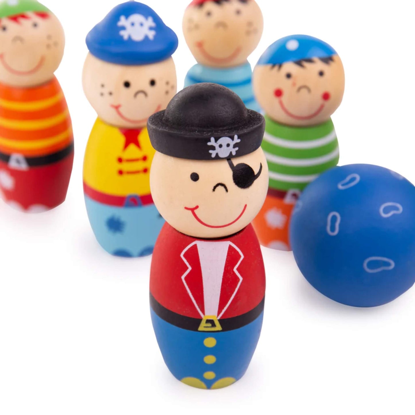 Close-up of wooden pirate skittles with painted outfits and a blue bowling ball in the foreground, arranged for play.