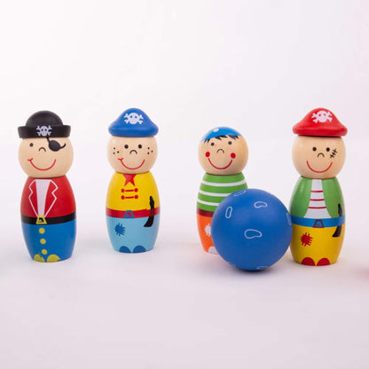 Four pirate skittles and a blue ball lined up on a white surface, showing playful expressions and colourful painted details.