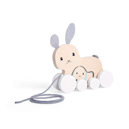 Side view of the Bigjigs pull along bunny toy with baby bunny nested underneath, showing soft felt ears and matching wheels.