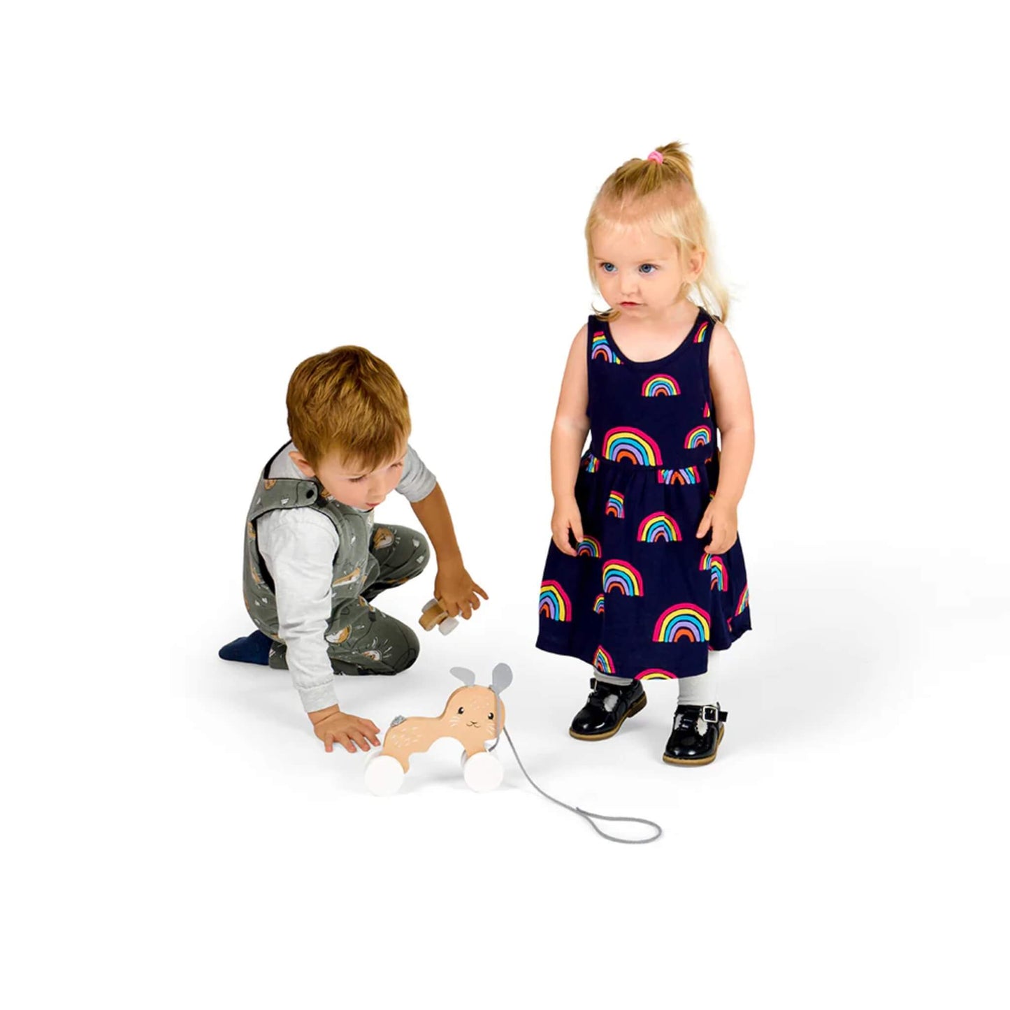 Toddler girl and young boy playing with the Bigjigs Pull Along Bunny & Baby, demonstrating toy size and child interaction.