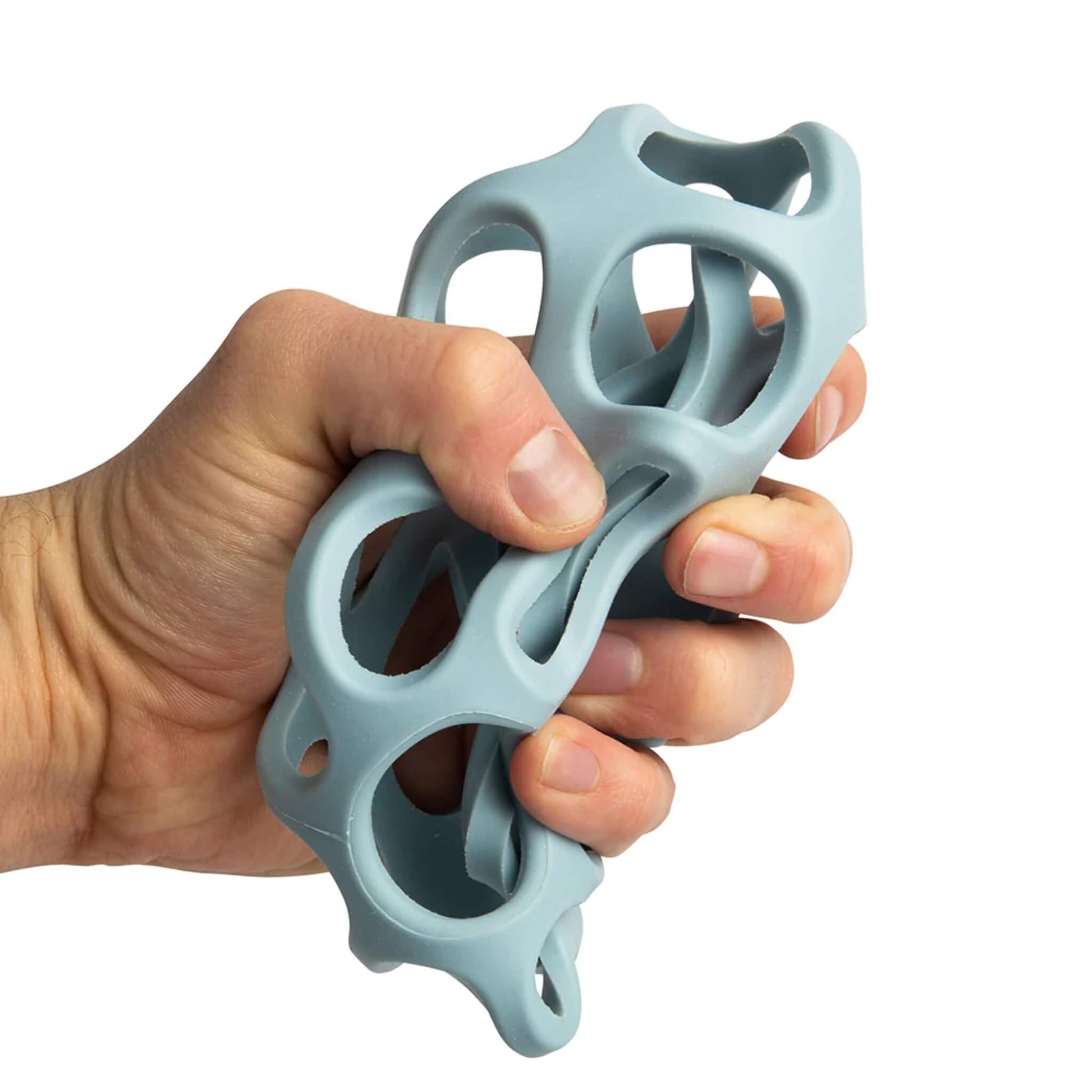 Adult hand squeezing the soft, flexible grey sensory ball from the silicone Activity Balls set.