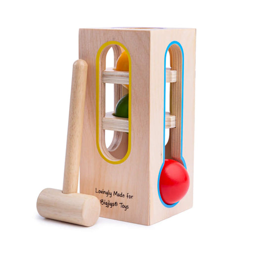 Bigjigs Toys Wooden Ball Fall tower with three colourful balls and a wooden hammer, designed for toddlers to develop hand-eye coordination and fine motor skills.