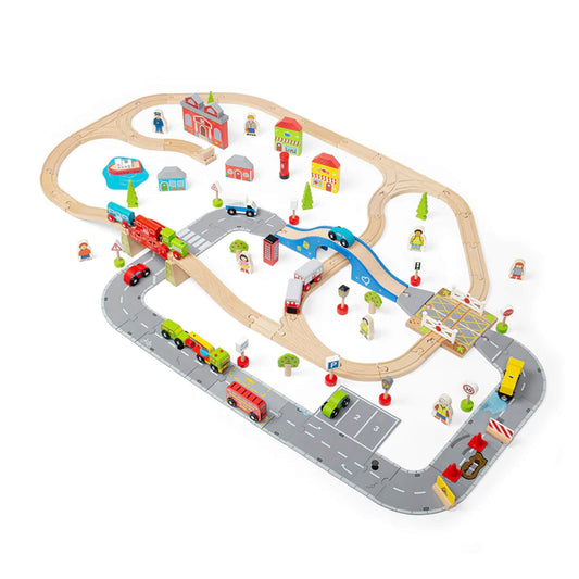 Complete Bigjigs Toys City Road and Railway Train Set assembled with wooden tracks, road layout, vehicles, buildings and figures on a plain white background.