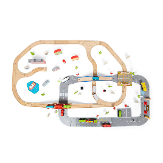 Top-down view of the full city road and railway layout showing road sections, curved wooden tracks, vehicles, buildings and trees spread across the play area.