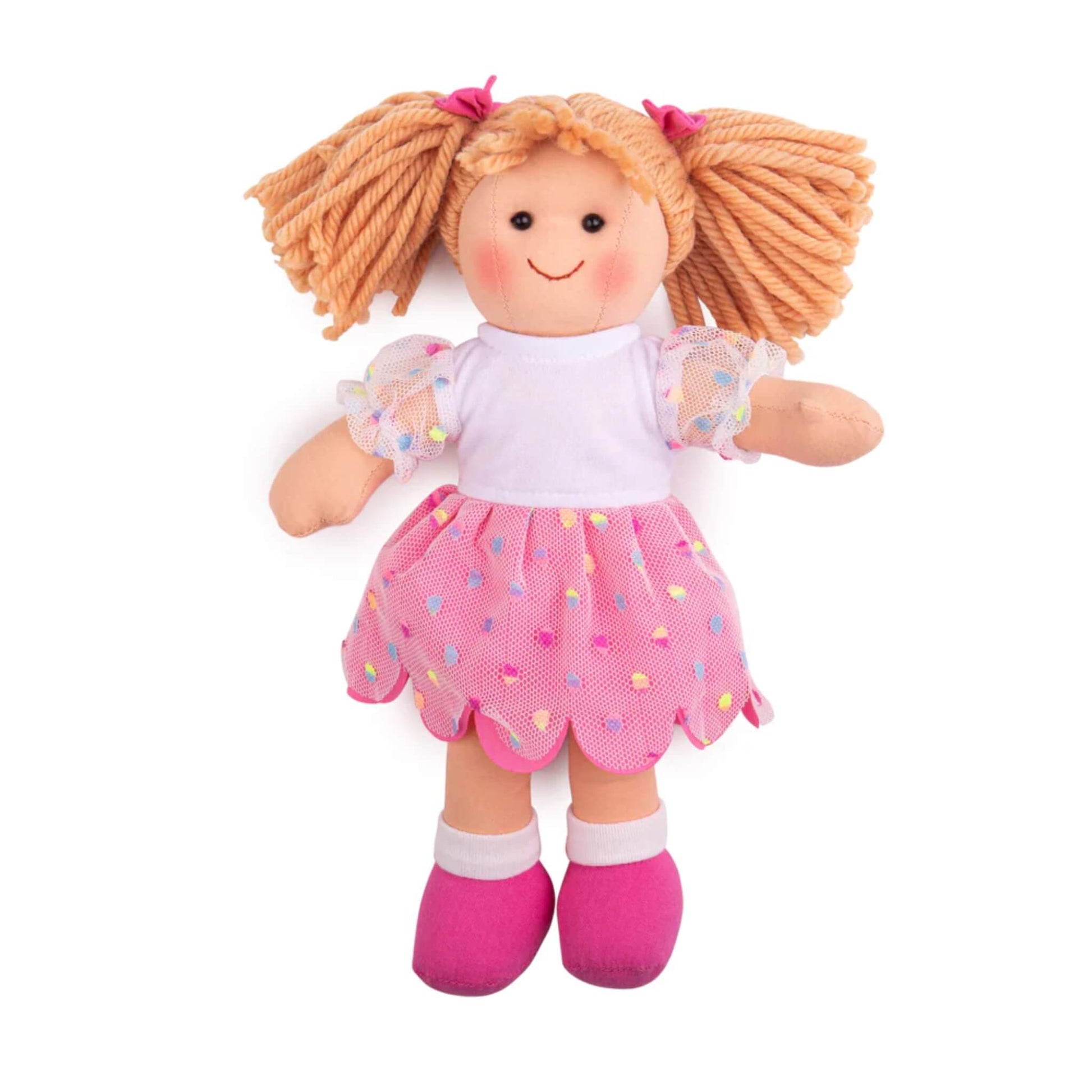 Bigjigs Toys Darcie Doll (Small) standing in a pink spotty mesh dress with pigtail yarn hair, bow details, and soft fabric limbs.