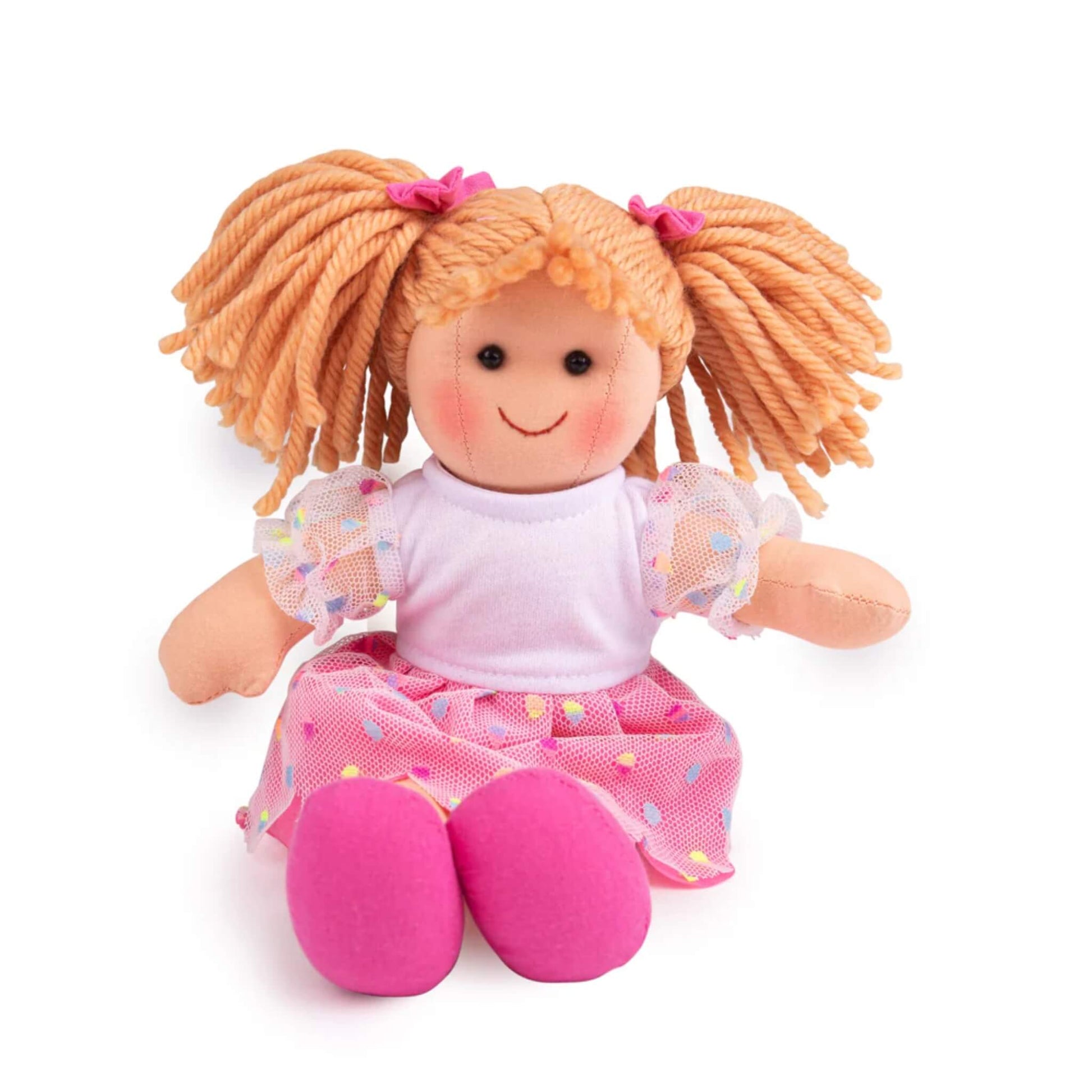 Darcie Doll sitting with legs outstretched, wearing a white top and scalloped pink mesh skirt with colourful spots.