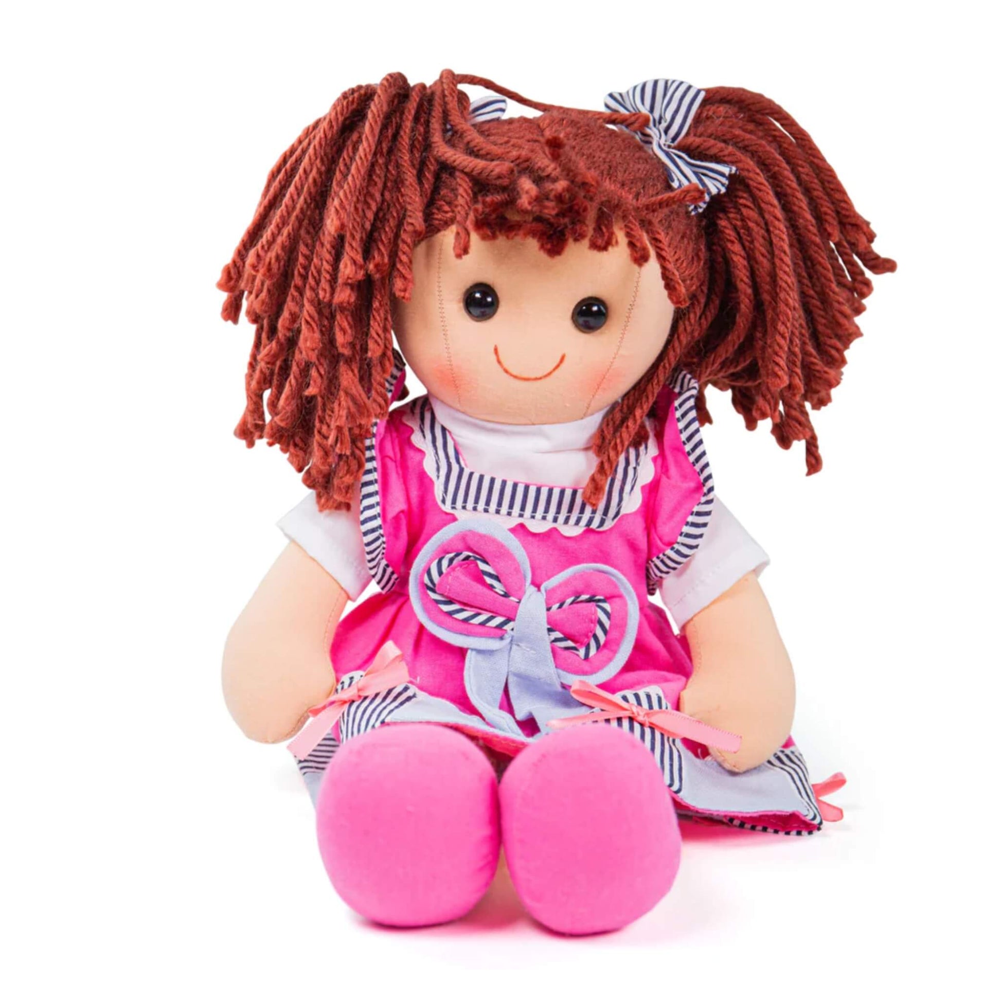Soft ragdoll Emma sitting upright with bunches tied in striped bows and bright pink shoes visible.