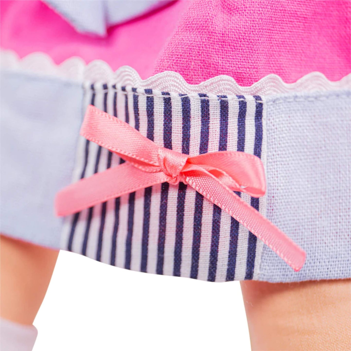 Pink ribbon bow stitched to the navy striped hem of Emma’s dress.