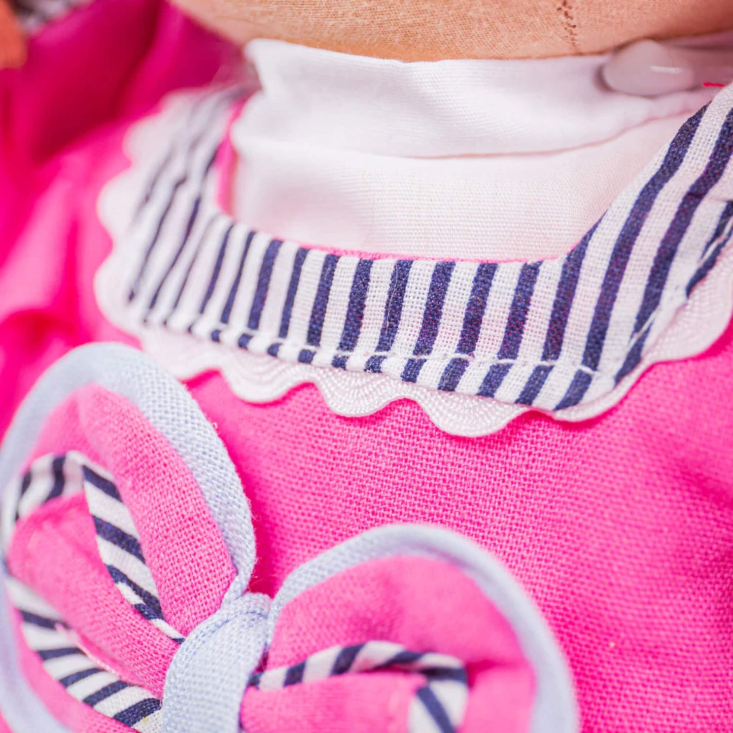 Close-up of the white and navy striped collar with scalloped trim.