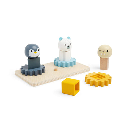 Penguin, polar bear, and walrus figures on the Bigjigs Toys FSC® Arctic Cog Board – a wooden shape sorter and cog puzzle for fine motor skill development.