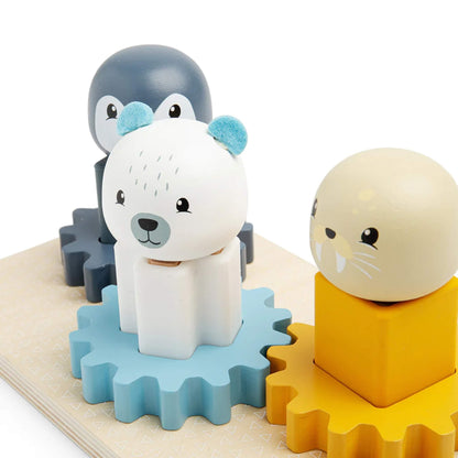 Close-up of polar bear, penguin, and walrus figures on cog board, highlighting the colourful silicone shapes and textured wooden pieces.