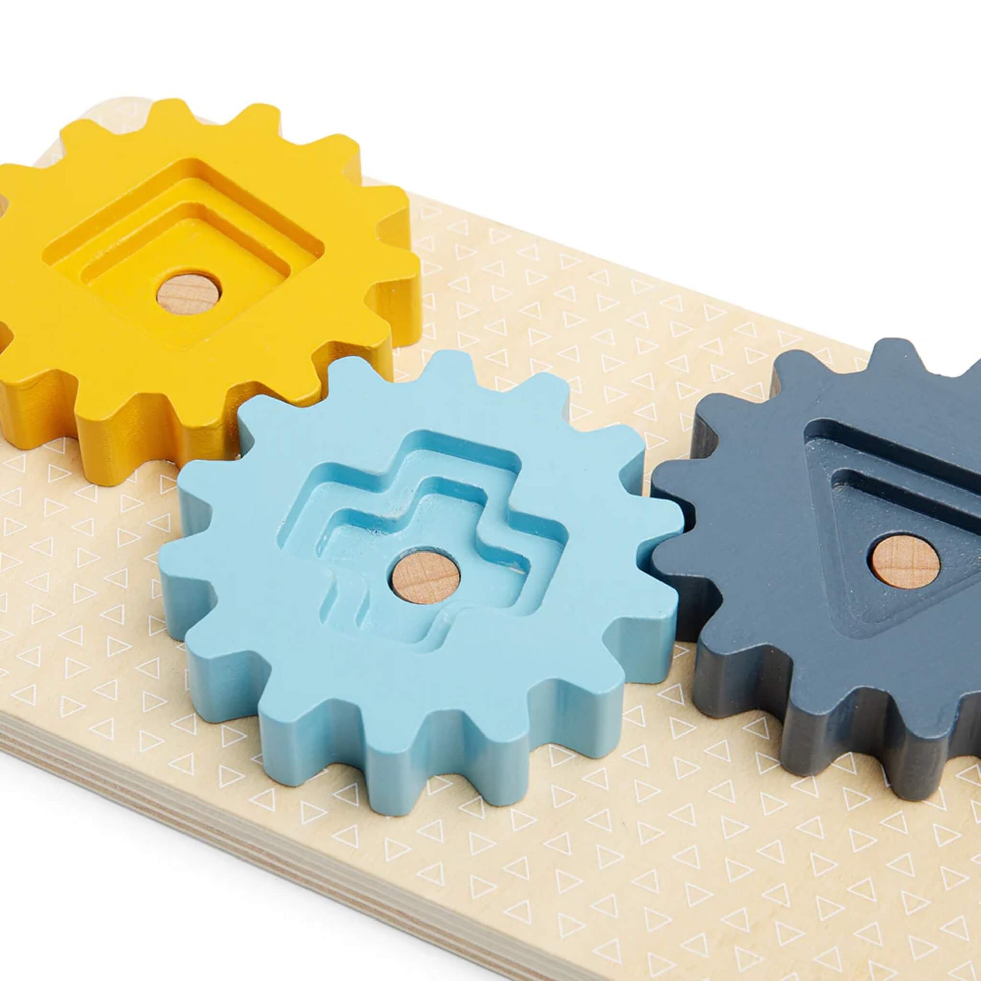 Close-up of yellow, blue, and grey cogs with textured shapes, ready for spinning and sorting.