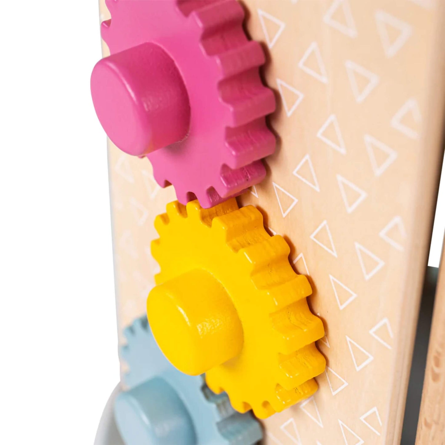 Zoomed view of the pink, yellow, and blue wooden cog gears on the side panel of the toy.
