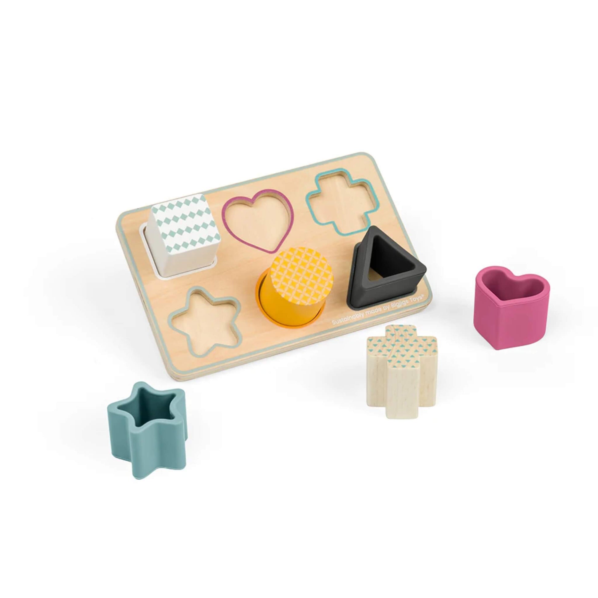 Bigjigs Toys FSC® Certified Shape Matching Board with six shapes—heart, star, circle, triangle, square and cross—made from wood and silicone, shown with pieces placed beside and inside the matching slots on the wooden board.