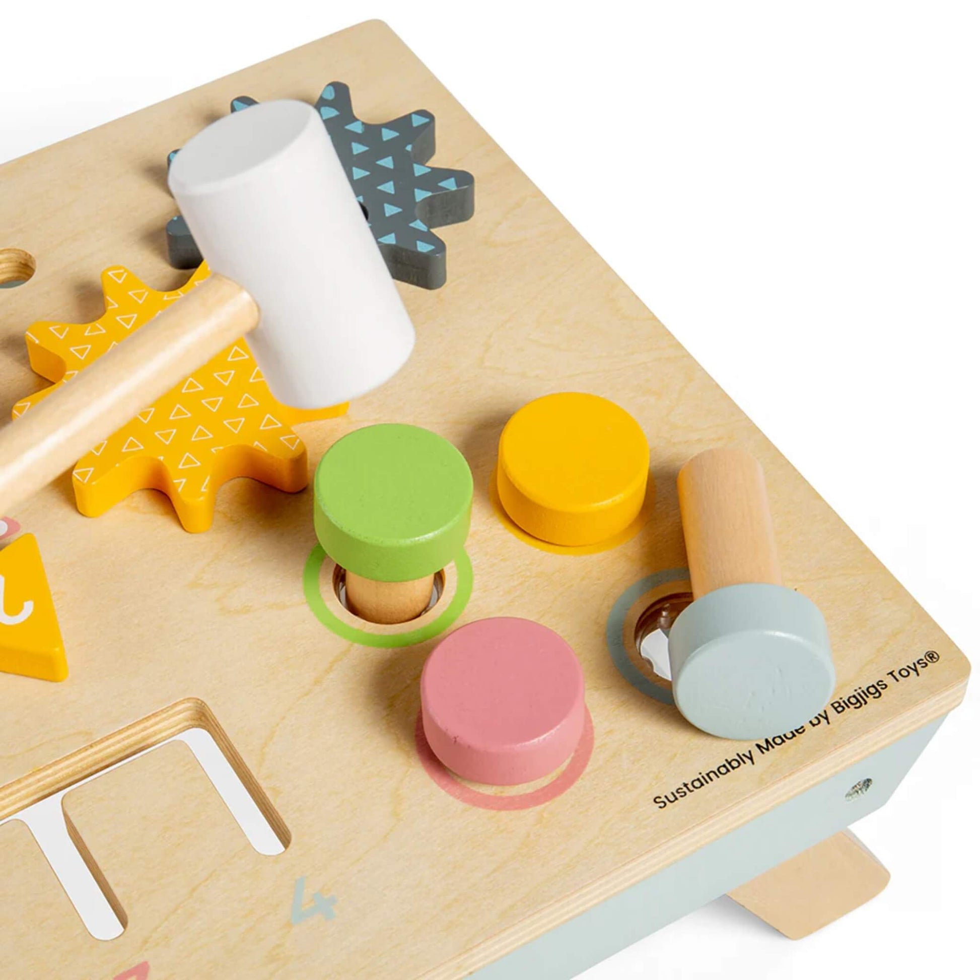 Zoomed-in view of the wooden activity table’s colourful cogs and pegs, with animal bolt heads and mallet nearby.