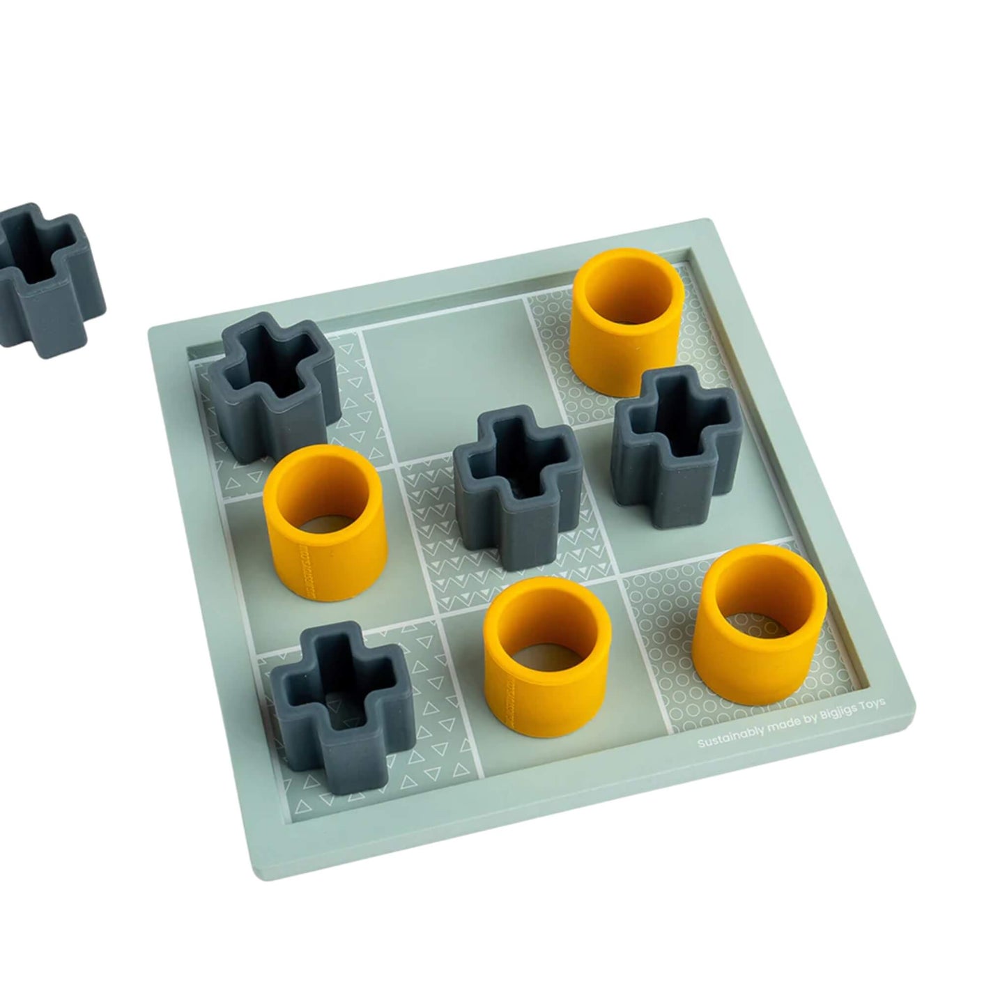 A flatlay of the Bigjigs Toys FSC® Certified Tic Tac Toe game in play, showing yellow noughts and grey crosses placed on the patterned wooden board.
