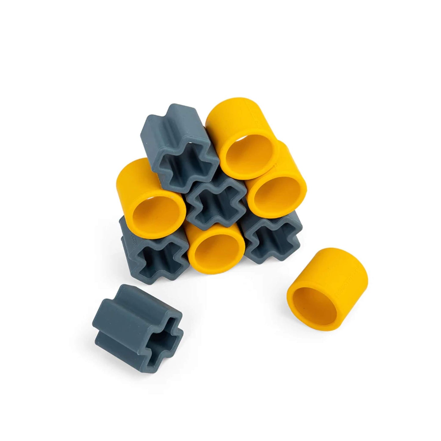 A view of the Tic Tac Toe pieces stacked loosely in a pile, highlighting the thick, durable silicone construction of the yellow and grey shapes.