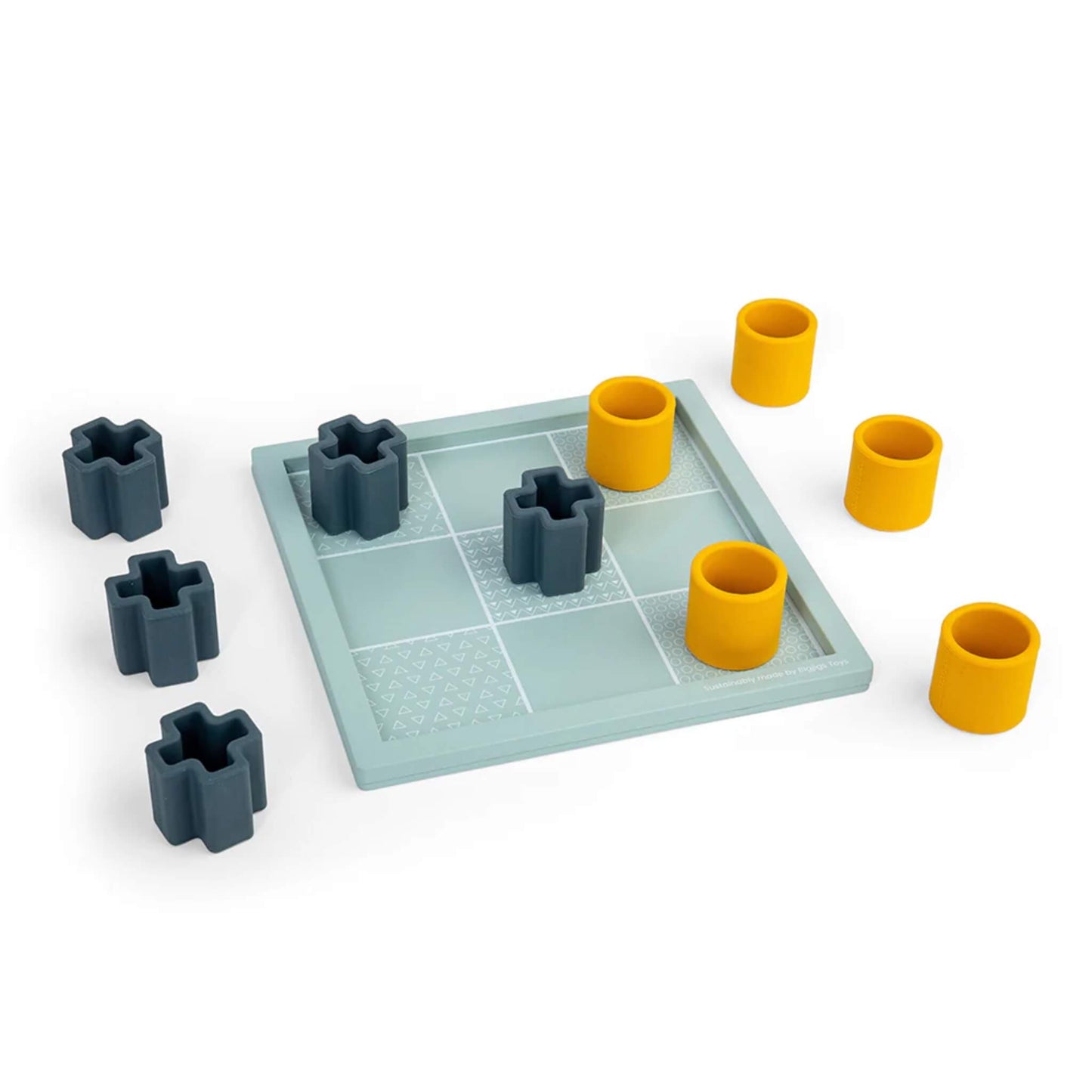 All nine playing pieces spread out on and around the Tic Tac Toe board, with the board’s etched textures clearly visible.