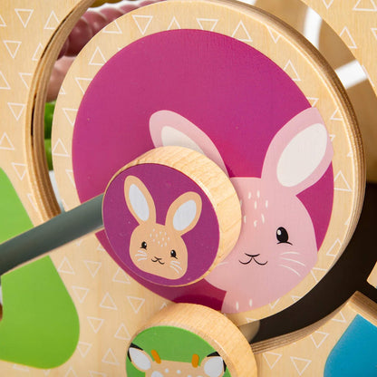 Wooden rotating animal disc showing a pink bunny illustration for matching and visual recognition.