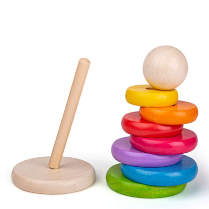 Bright rainbow rings arranged in size order with natural wooden topper, perfect for early learning.