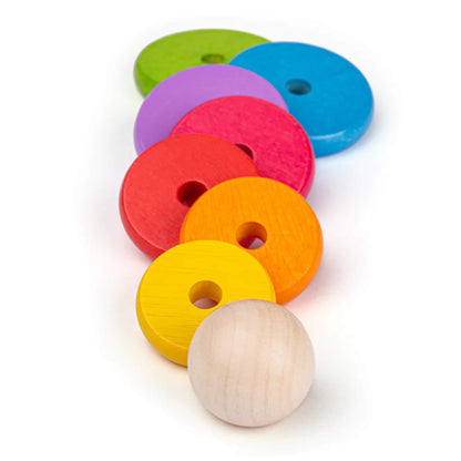 Wooden stacking rings in a line, arranged from largest to smallest – perfect for size and colour learning.
