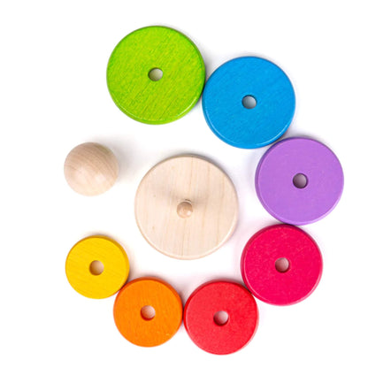 : Smooth, natural wooden base and colourful rings arranged in a rainbow circle, ready for stacking fun.