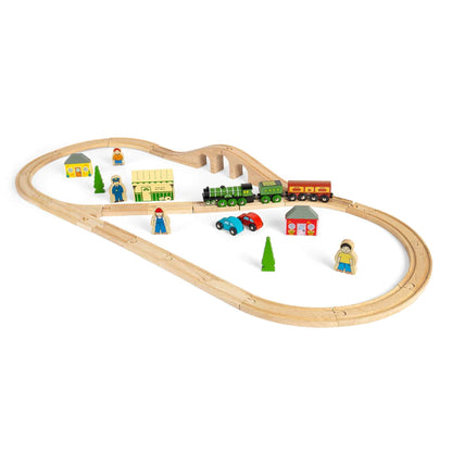 Angled view of the Bigjigs Flying Scotsman Set showing train crossing the bridge with station, cars, and accessories around the track.