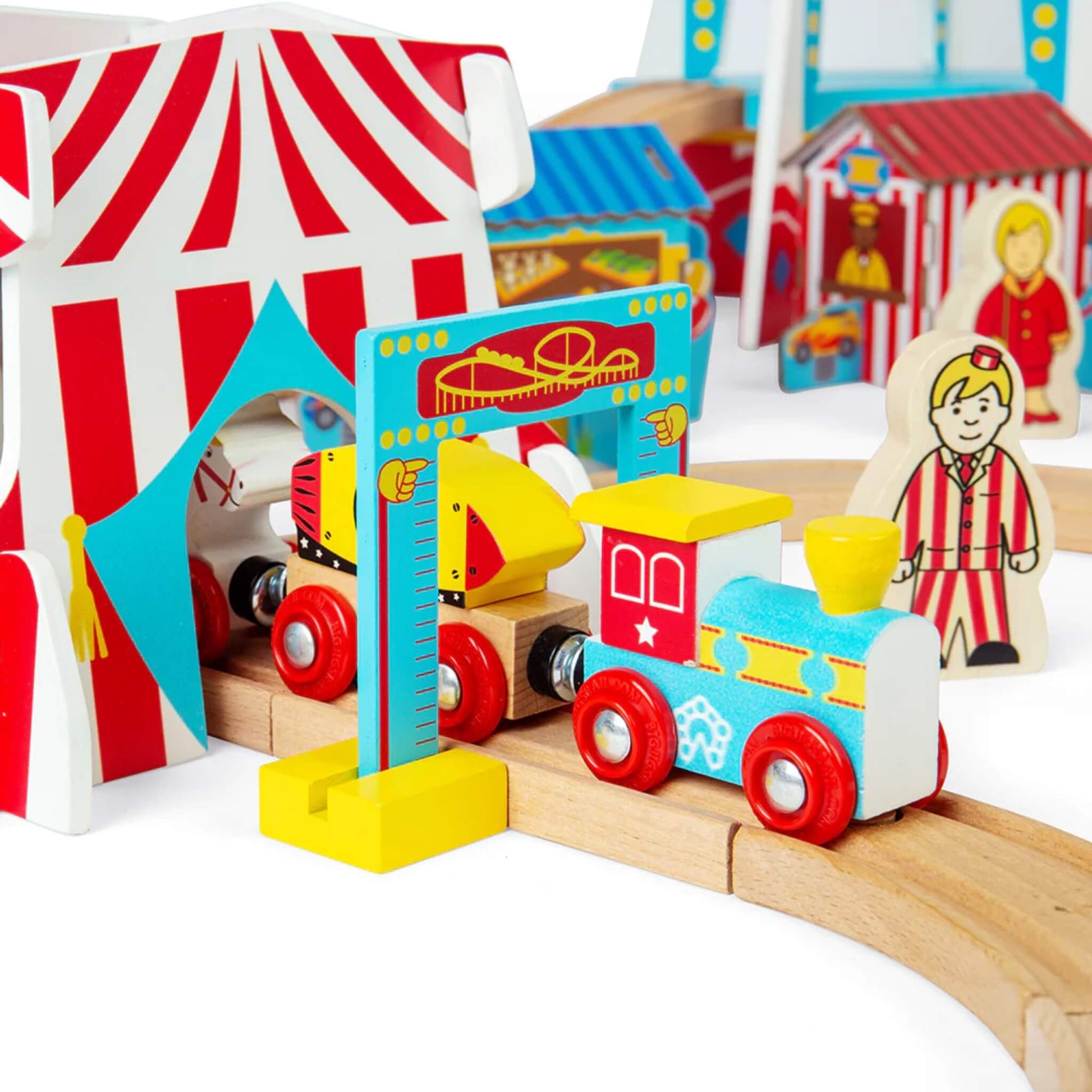 Bigjigs Toys carnival train passing through the height check arch and entering the red-and-white striped circus tent.