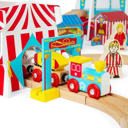 Bigjigs Toys carnival train passing through the height check arch and entering the red-and-white striped circus tent.