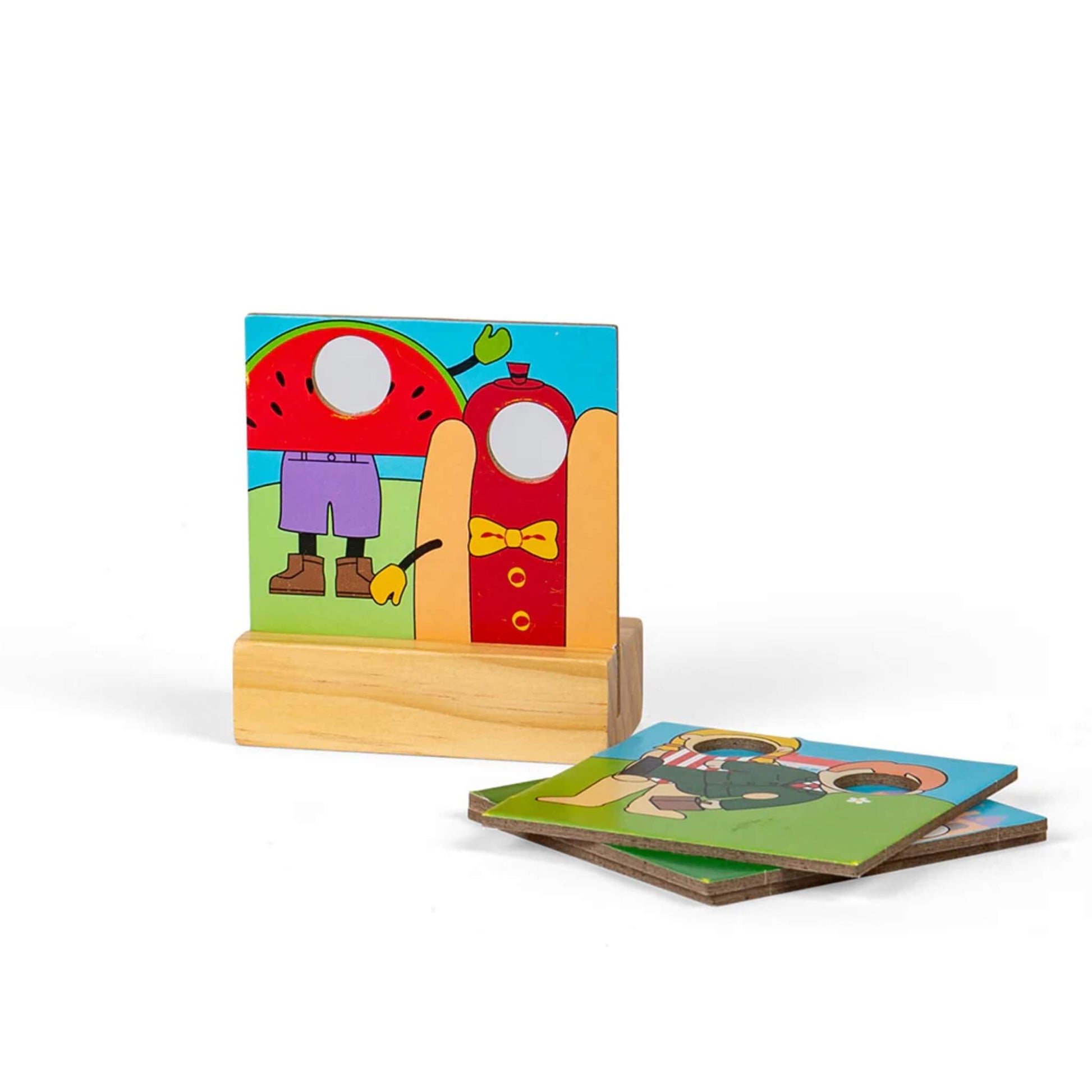  Wooden face-in-hole stand with alternate fairground-themed panel pieces laid next to it.