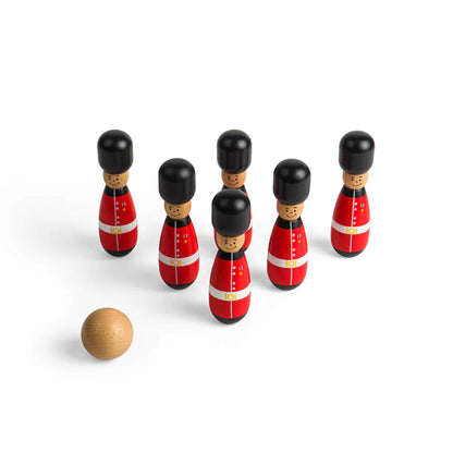 Overhead view of the guardsman skittles formation with a plain wooden ball about to be rolled toward them.