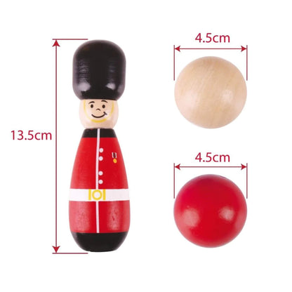 Close-up showing the height and width measurements of a single guardsman skittle (13.5cm tall) alongside two wooden balls, each 4.5cm wide.