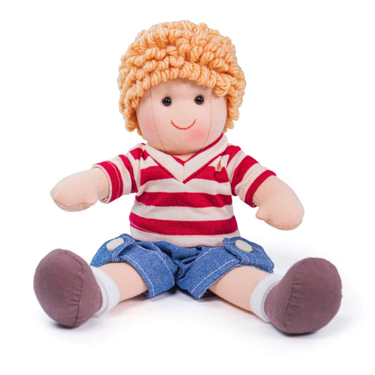 Small soft doll seated with hands outstretched, wearing blue shorts and a striped rugby-style top.